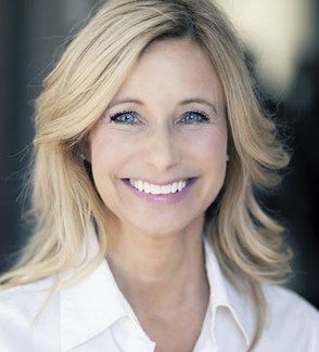 Smiling woman with blonde hair and blue eyes